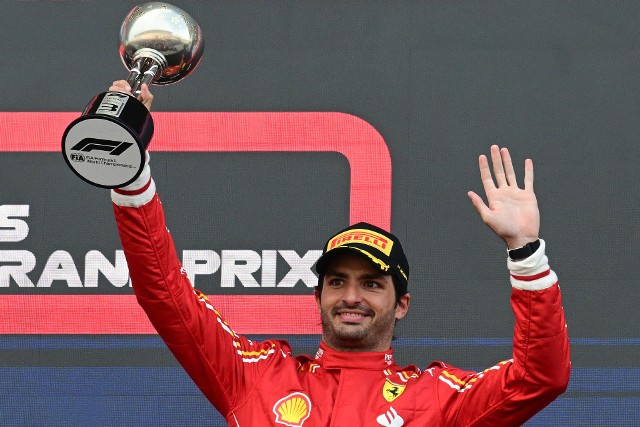 Ferrari's Spanish driver Carlos Sainz Jr celebrates taking third place on the podium after the end of the Formula One Japanese Grand Prix race at the Suzuka circuit in Suzuka, Mie prefecture on April 7, 2024. (Photo by Yuichi YAMAZAKI / AFP)